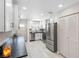 Kitchen with modern appliances, white cabinetry, and light tile floors at 3010 59Th S St # 304, Gulfport, FL 33707