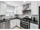 Updated kitchen with white cabinets, stainless steel appliances and modern style at 3010 59Th S St # 304, Gulfport, FL 33707