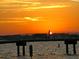 Picturesque sunset view from the pier with a silhouette of a lone person at 3010 59Th S St # 304, Gulfport, FL 33707