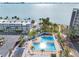Aerial view of a community pool area with palm trees and waterfront views at 3010 59Th S St # 304, Gulfport, FL 33707