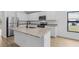 Modern kitchen featuring white cabinets, stainless appliances, granite counters, and a kitchen island at 3378 Escobar Ln, North Port, FL 34286