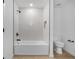 Modern bathroom with a tub, sleek shower, and neutral tile, complemented by dark fixtures at 3560 Bellefonte Ave, North Port, FL 34286