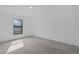 Bright, carpeted bedroom with a window offering natural light and a neutral color scheme at 3560 Bellefonte Ave, North Port, FL 34286