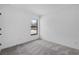 Bright, empty bedroom with a window offering natural light and neutral-colored carpet at 3560 Bellefonte Ave, North Port, FL 34286