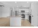 Modern kitchen with stainless steel appliances, granite countertops, a kitchen island, and white cabinets at 3560 Bellefonte Ave, North Port, FL 34286