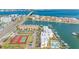 Aerial view of condo complex with pool, tennis courts, and waterfront access to bay at 363 Pinellas Bayway S # 41, Tierra Verde, FL 33715