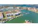 An aerial view of the condo buildings, a swimming pool, a tennis court, and boat docks at 363 Pinellas Bayway S # 41, Tierra Verde, FL 33715