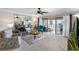 Open living area featuring a waterfront view and sliding glass doors leading to an outdoor patio at 363 Pinellas Bayway S # 41, Tierra Verde, FL 33715