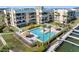 Inviting pool area with tiki umbrellas and ample seating at waterfront condos at 363 Pinellas Bayway S # 41, Tierra Verde, FL 33715