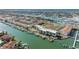 Aerial view showcasing waterfront condos, a pool, tennis courts, and boat docks with stunning water views at 363 Pinellas Bayway S # 41, Tierra Verde, FL 33715
