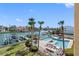 Scenic aerial view showcasing the waterfront with boat docks, a community pool, and lush landscaping at 363 Pinellas Bayway S # 41, Tierra Verde, FL 33715