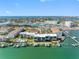 Stunning aerial view of waterfront condos, docks, boat slips and neighborhood, offering a resort-style living at 363 Pinellas Bayway S # 41, Tierra Verde, FL 33715