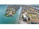 Aerial shot of waterfront condos featuring boat docks, lush landscaping, and stunning views of the open water at 363 Pinellas Bayway S # 41, Tierra Verde, FL 33715