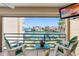 Relaxing balcony with waterfront views, comfortable seating, and a TV for outdoor entertainment at 363 Pinellas Bayway S # 41, Tierra Verde, FL 33715
