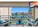 Scenic balcony view overlooking the waterfront with comfortable seating and a mounted television at 363 Pinellas Bayway S # 41, Tierra Verde, FL 33715