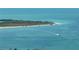 Expansive view of clear blue ocean water meets a sandy beach, showing the natural beauty of the location at 363 Pinellas Bayway S # 41, Tierra Verde, FL 33715