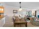 Cozy dining area with a wooden table set, stylish lighting, and a view into the living room at 363 Pinellas Bayway S # 41, Tierra Verde, FL 33715
