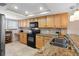 Bright kitchen features tan cabinetry, granite countertops, stainless steel appliances, and recessed lighting at 363 Pinellas Bayway S # 41, Tierra Verde, FL 33715