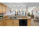 Bright kitchen features tan cabinetry, granite countertops, and overlooks the cozy living space at 363 Pinellas Bayway S # 41, Tierra Verde, FL 33715