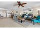 Bright living room featuring a ceiling fan, modern furniture, and an open floor plan at 363 Pinellas Bayway S # 41, Tierra Verde, FL 33715