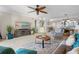 Inviting living room with plush seating, a modern ceiling fan, and a decorative entertainment center at 363 Pinellas Bayway S # 41, Tierra Verde, FL 33715