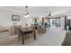 Bright living area featuring neutral tones, modern furniture, dining area, and sliding glass doors to outdoor patio at 363 Pinellas Bayway S # 41, Tierra Verde, FL 33715