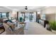 Inviting living room featuring comfortable seating, neutral decor, and seamless access to an outdoor balcony at 363 Pinellas Bayway S # 41, Tierra Verde, FL 33715