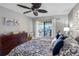 Relaxing main bedroom features a ceiling fan, dresser, and balcony with a water view at 363 Pinellas Bayway S # 41, Tierra Verde, FL 33715