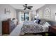 This cozy main bedroom features ceiling fan, dresser and balcony with gorgeous water view at 363 Pinellas Bayway S # 41, Tierra Verde, FL 33715