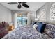 Comfortable main bedroom features a ceiling fan and a balcony with a water view at 363 Pinellas Bayway S # 41, Tierra Verde, FL 33715