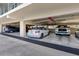 Well-lit parking garage featuring multiple vehicles under a concrete structure, ensuring secure parking at 363 Pinellas Bayway S # 41, Tierra Verde, FL 33715
