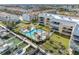 Exterior shot featuring condos, community pool, lush landscaping, and boat docks for perfect waterfront living at 363 Pinellas Bayway S # 41, Tierra Verde, FL 33715