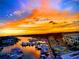 A picturesque sunset view overlooks boats docked in the waterway, reflecting vivid orange colors at 363 Pinellas Bayway S # 41, Tierra Verde, FL 33715