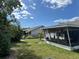 Spacious backyard with the house and lanai area and some trees at 3722 Haven Dr, New Port Richey, FL 34652