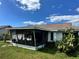 View of the backyard with a screened lanai and lush greenery at 3722 Haven Dr, New Port Richey, FL 34652
