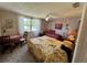 Bedroom with floral wallpaper, ceiling fan, and multiple beds and side tables at 3722 Haven Dr, New Port Richey, FL 34652