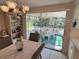Comfortable dining room with chandelier and screened lanai beyond a glass sliding door at 3722 Haven Dr, New Port Richey, FL 34652