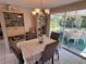 Charming dining area with a chandelier and screened patio access for outdoor relaxation at 3722 Haven Dr, New Port Richey, FL 34652