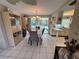 Dining room adjacent to the kitchen features tile flooring, dining table and access to an enclosed patio at 3722 Haven Dr, New Port Richey, FL 34652