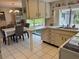 Functional kitchen and dining area with a breakfast bar, modern appliances, and garden view at 3722 Haven Dr, New Port Richey, FL 34652