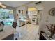 Kitchen with breakfast bar adjacent to a dining area features white cabinets and white appliances at 3722 Haven Dr, New Port Richey, FL 34652
