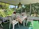 Enclosed lanai with green carpet and a white table and chairs at 3722 Haven Dr, New Port Richey, FL 34652