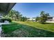 Backyard features well-manicured lawn and trees, offering a serene outdoor space at 4154 57Th N St # 173, Kenneth City, FL 33709