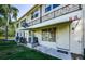 Condo exterior featuring awning, door, wrought iron, and air conditioning units on the side of the building at 4154 57Th N St # 173, Kenneth City, FL 33709