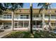 Condo building with second-story balconies and ground floor screened patios at 4154 57Th N St # 173, Kenneth City, FL 33709