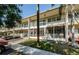 Beige two-story condo building featuring screened patios and second-story decorative railings at 4154 57Th N St # 173, Kenneth City, FL 33709