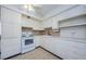Bright kitchen with ample cabinetry, ceiling fan, and functional layout at 4154 57Th N St # 173, Kenneth City, FL 33709