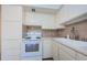 Functional kitchen features white appliances, spacious counter tops, and ample cabinet space at 4154 57Th N St # 173, Kenneth City, FL 33709