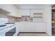 Classic kitchen design featuring white cabinets and appliances for a bright, clean, and functional cooking space at 4154 57Th N St # 173, Kenneth City, FL 33709