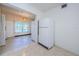 View of the kitchen with a white refrigerator and ample storage, connected to a sunlit dining area at 4154 57Th N St # 173, Kenneth City, FL 33709